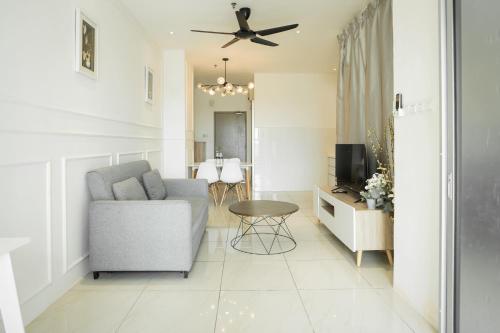 a living room with a couch and a ceiling fan at ITCC Manhattan Suites by Calvin in Donggongon