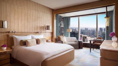 a hotel room with a bed and a large window at The Ritz-Carlton Shanghai, Pudong in Shanghai