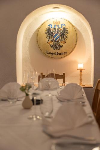 a table with a white table cloth with a crest on it at Vogelbauer Einliegerwohnung in Neufahrn