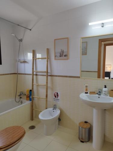 a bathroom with a sink and a toilet and a tub at Casa La Ola Majanicho - Monthly Stays in Majanicho