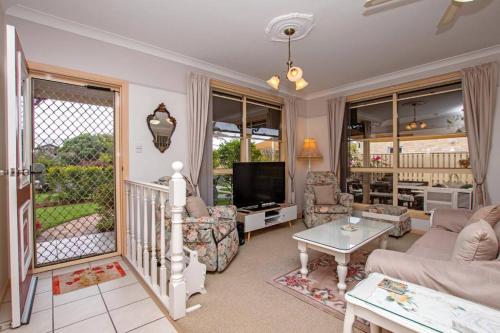 a living room with a couch and a tv at Ballina Beachside Retreat 3 min Walk onto Beach in East Ballina