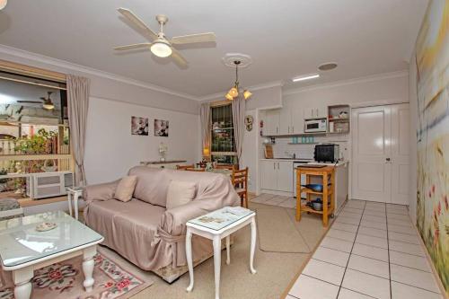 a living room with a couch and a table at Ballina Beachside Retreat 3 min Walk onto Beach in East Ballina