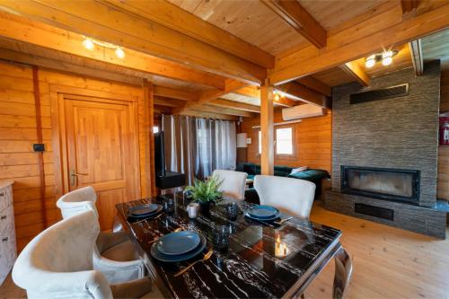 a dining room with a table and chairs and a fireplace at Ktima To Alliotiko - Lofou 1 in Lofou
