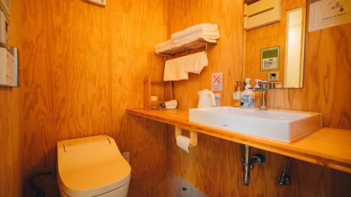 a bathroom with a sink and a toilet at Dot Glamping 富士山 in Fujikawaguchiko