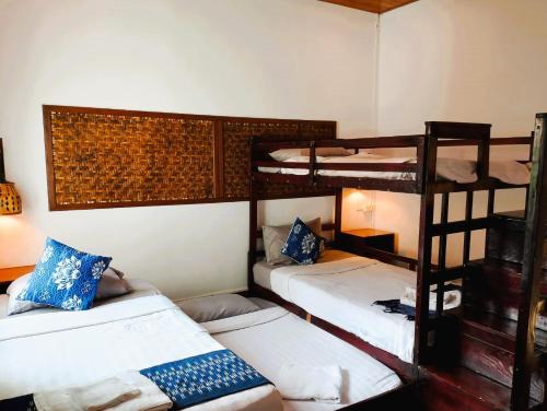 a room with three bunk beds in it at Villa Sala Vanna in Savannakhet