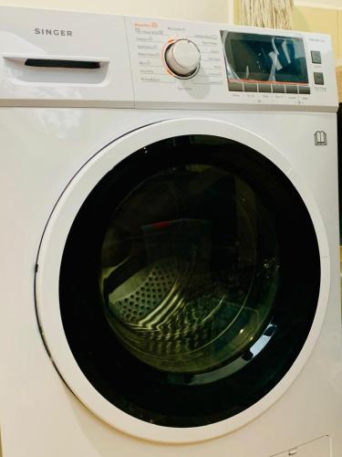 a white washing machine with its door open at 007Dickoya in Dikoya