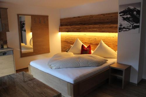a bedroom with a bed and a lamp at Pension Michael in Saalbach-Hinterglemm