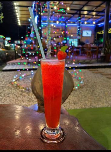 a drink sitting on a table with a strawberry in it at Khao Sok Country Resort in Khao Sok