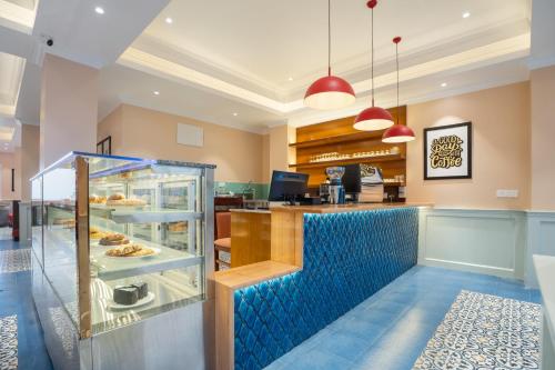 a restaurant with a blue counter with a buffet at Preisha Hotel and Resorts in Gangtok