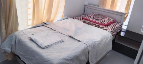 a bed with two pillows on it next to a window at Vihaara Wayanad Serviced Villa in Ambalavayal