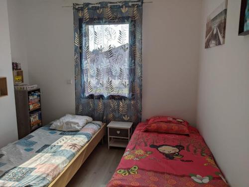 une chambre avec deux lits et une fenêtre dans l'établissement Maison récente, à Chaumes en Retz