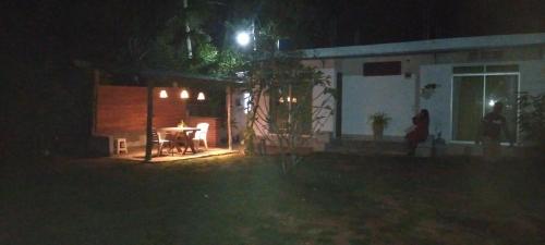 a house at night with a table in front of it at Sun Beach Villa in Weligama