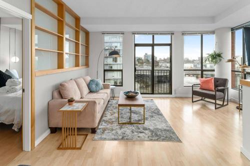 a living room with a couch and a table at Waterfront Stay With Balcony And Bbq in Victoria
