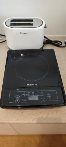 a tablet computer sitting on a counter next to a toaster at Randy's Seaview Studio in Negombo