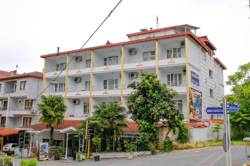 a large white building on the side of a street at Green Moringa Termal Hotel in Termal
