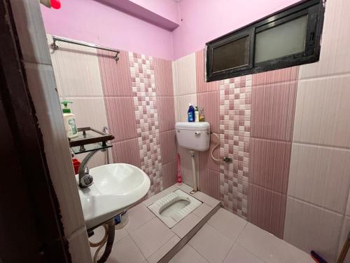 a small bathroom with a sink and a toilet at Kathmandu Valley View Homestay in Kathmandu