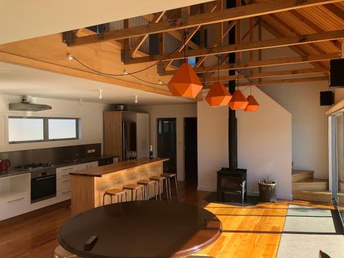 a kitchen with a black table and a stove at Private home - Perfect Stay for visiting Tongariro & Southern Lake Taupo in Kuratau