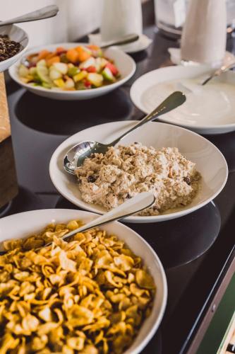 a table topped with plates of food and bowls of food at Hotel Bussi Baby in Bad Wiessee