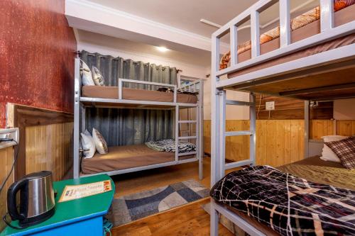 a room with two bunk beds in a house at The Bougainvillea, Mcleodganj in Dharamshala