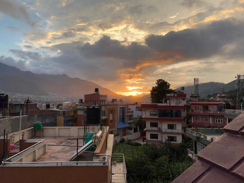 a view of a city with the sunset in the background at Kathmandu Valley View Homestay in Kathmandu