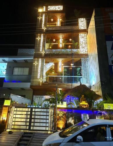 a building with a white car parked in front of it at 3BHK floor in urban homestay-swiming pool, Jacuzzi in Zirakpur