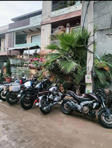 a row of motorcycles parked in front of a building at 3BHK floor in urban homestay-swiming pool, Jacuzzi in Zirakpur