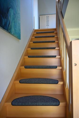 a set of stairs in a house with mats on them at Ferienhaus Frida am Deich in Wesselburenerkoog