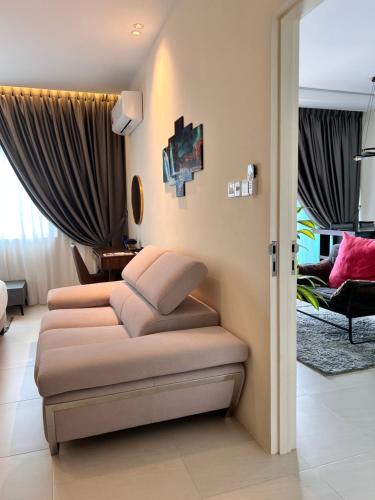 a living room with a couch in a room at LoFF Suite River View 2 Bedroom at Kuching Riverine Resort in Kuching