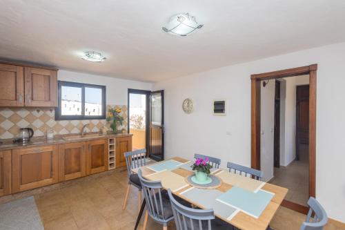a kitchen and dining room with a table and chairs at Moya Rooftop House - 3BR in Moya