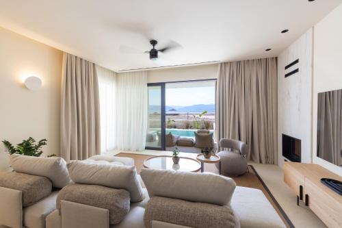 a living room with a couch and a table at Ilva Suites in Nafplio