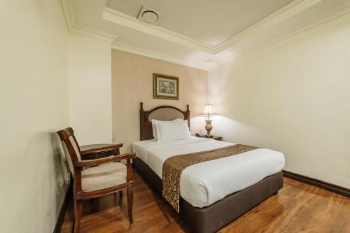 Ένα ή περισσότερα κρεβάτια σε δωμάτιο στο Villa Caceres Hotel