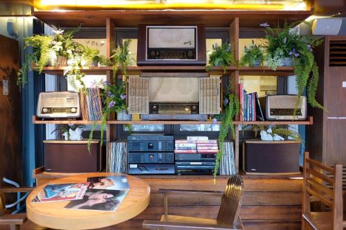 a living room with a table and several radios at Siam Champs Elyseesi Unique Hotel in Bangkok