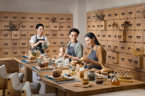a group of three people sitting around a table at Six Senses Kyoto in Kyoto