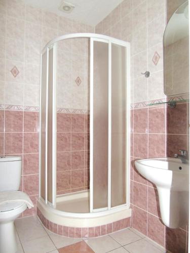 a bathroom with a shower and a toilet and a sink at Toris Inn in Třinec