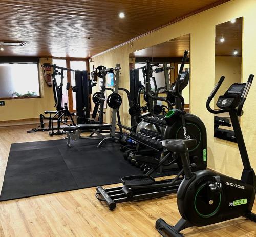 a gym with several treadmills and exercise bikes at Albir Hills Apartments in Albir