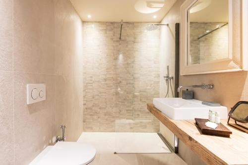 a bathroom with a toilet and a sink and a shower at ASILO in BAROLO - The apartments in Barolo