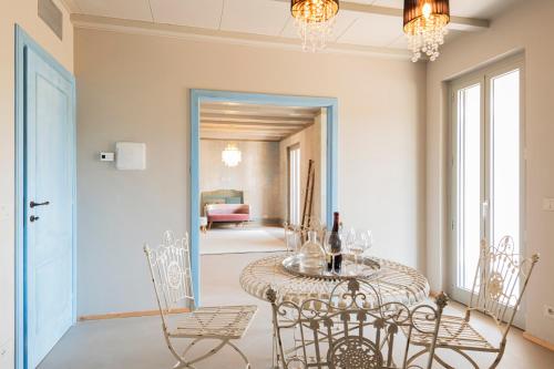 a dining room with a table and chairs at ASILO in BAROLO - The apartments in Barolo