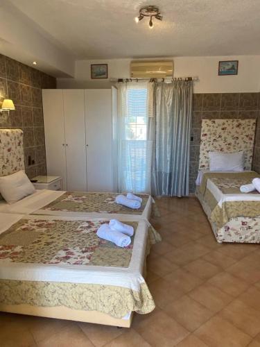 a bedroom with two beds with towels on them at RESIDENTS IONIAN (BED AND BREAKFAST) in Argostoli
