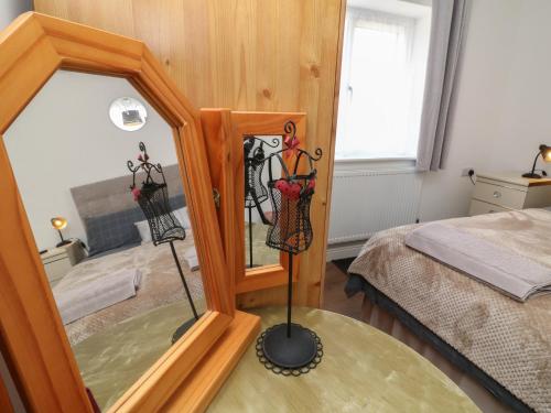 a mirror in front of a bedroom with a bed at Scenic Views in High Bickington