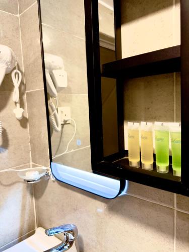 a mirror above a sink in a bathroom at Ammura rum camp in Wadi Rum