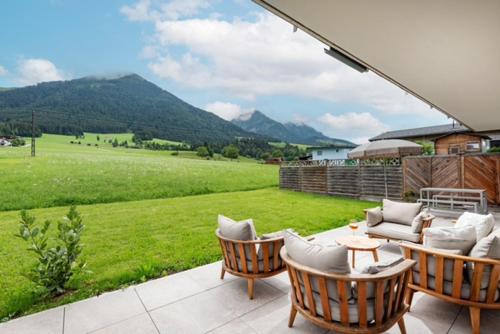 a patio with chairs and a view of a field at Alpflair Urlaubsdomizil in Oed