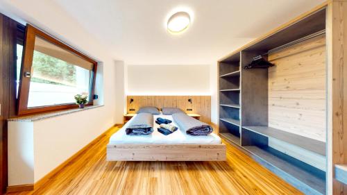 a bedroom with a bed in a room with a window at Haus Moritz in Oetz