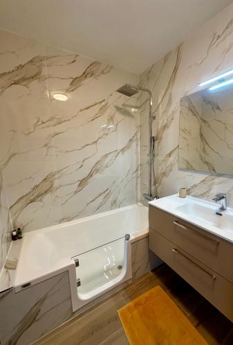 une salle de bain blanche avec un lavabo et un miroir dans l'établissement T2 Mandelieu Cannes - Résidence calme -piscine - proche commodités, à Mandelieu-la-Napoule