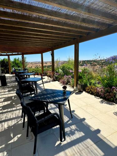 a group of tables and chairs on a patio at Vistas - Herdade do Zambujal in Castro Verde