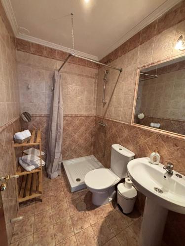 a bathroom with a toilet and a sink at Casa Beatriz in Cambados