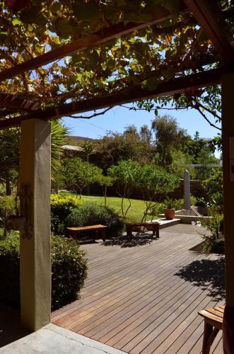 a wooden deck with benches in a park at Villa Limonicella in Barrydale