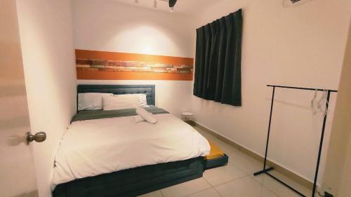 a small bedroom with a bed with an orange stripe at Kulai d'putra suites beside ioiMall near Airport and JPO in Kulai