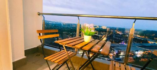 a wooden table with flowers on top of a balcony at Kulai d'putra suites beside ioiMall near Airport and JPO in Kulai