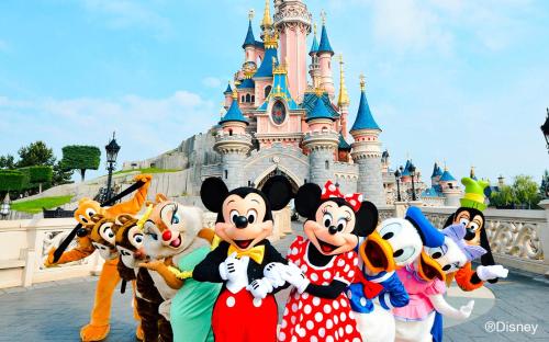 a group of mario and mickeys in front of disney castle at Cosy Apartment - Parking, Garden,10mn from Disneyland! in Montévrain