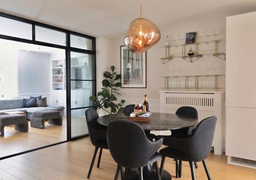 a living room with a dining room table and chairs at Central City Apartment in Copenhagen in Copenhagen